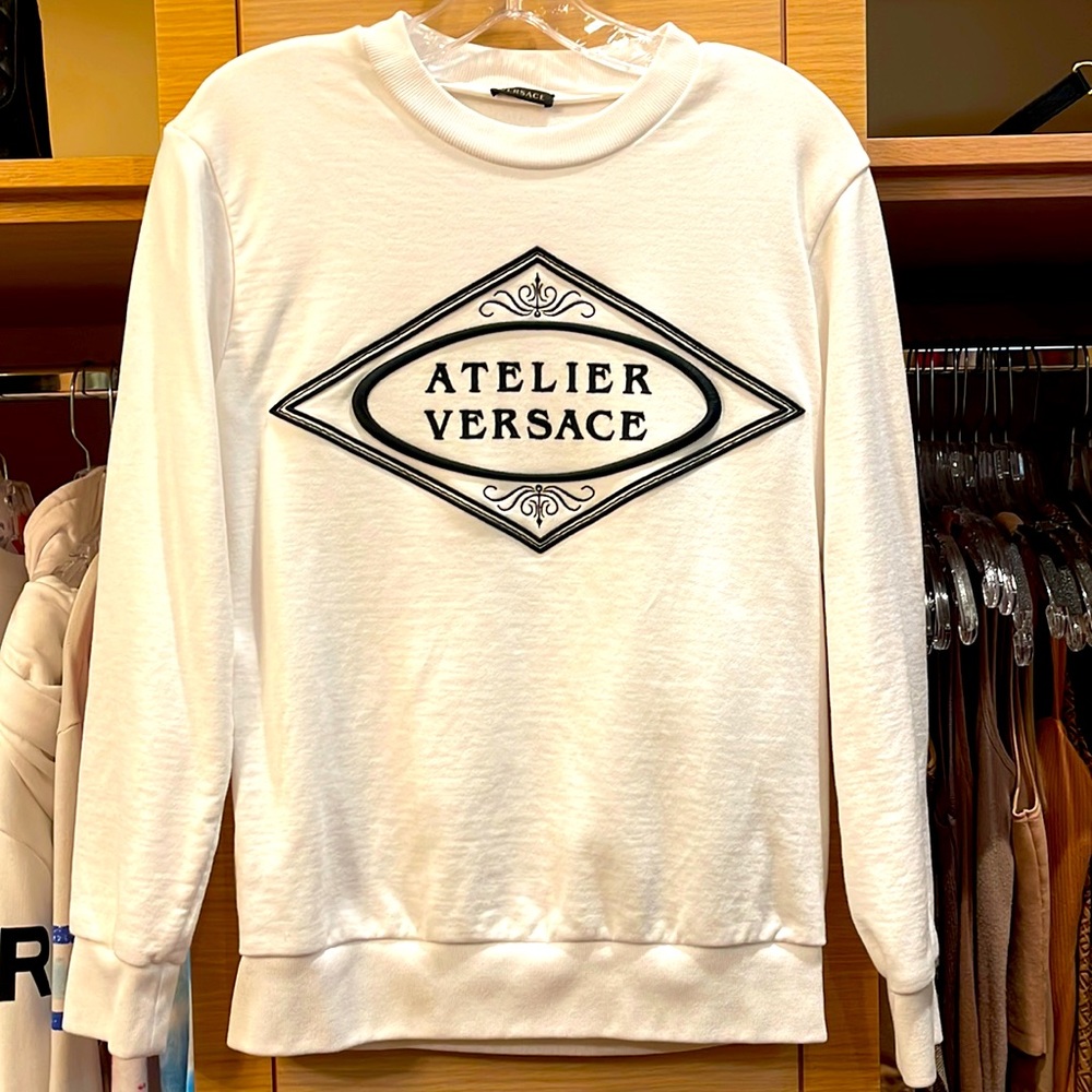 Versace white sweatshirt with Atelier Versace embroidered on front.